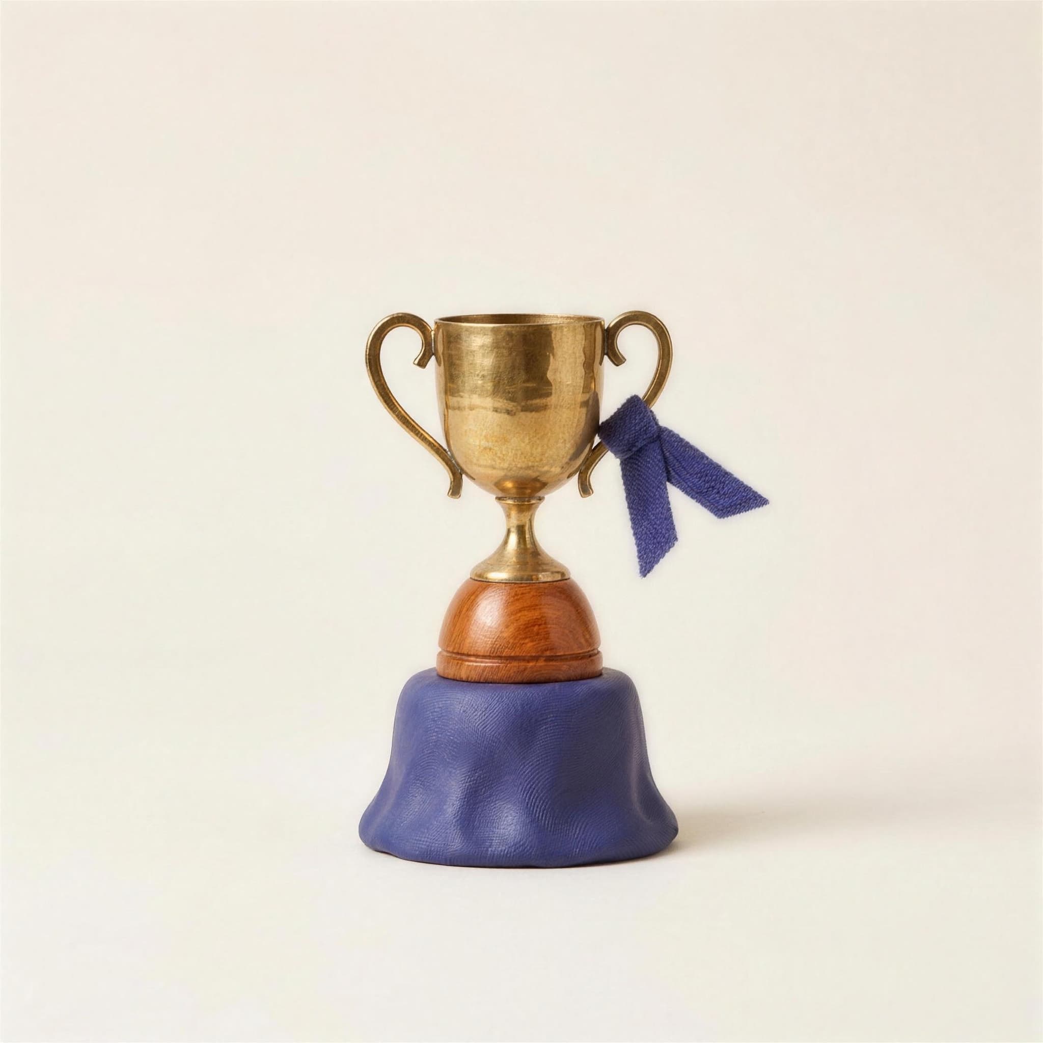 A brass trophy on an indigo felt base